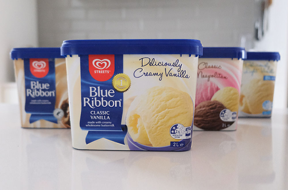 A row of Blue Ribbon Ice Cream tubs on a kitchen bench.