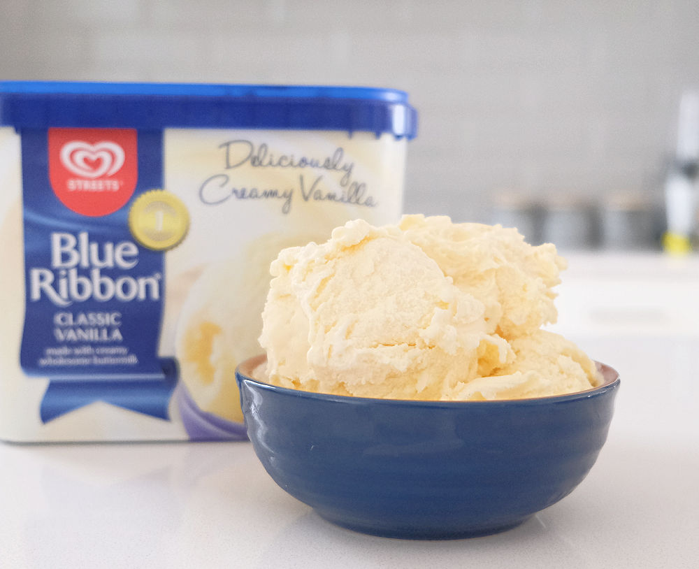 A bowl with scoops of Blue Ribbon Classic Vanilla ice cream made by Streets.