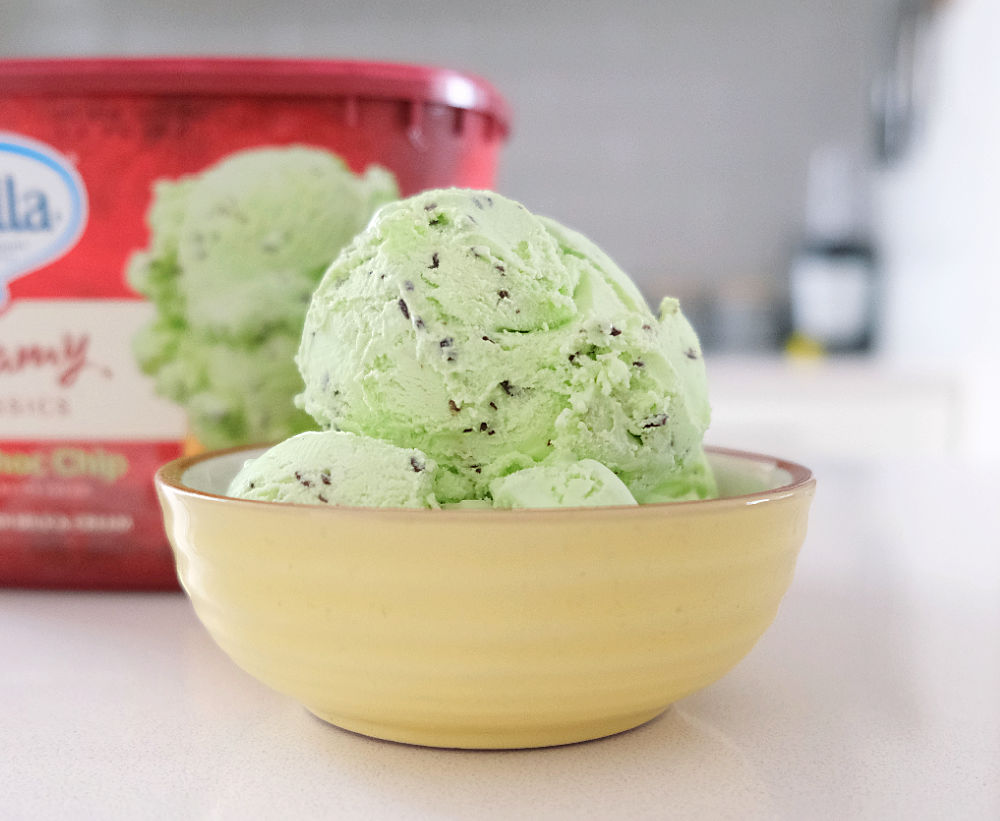 A bowl of mint chip ice cream with the Bulla tub in the background.