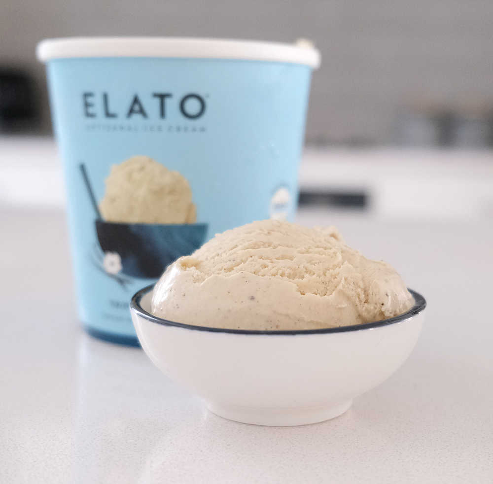 A bowl of triple vanilla with the container behind it.