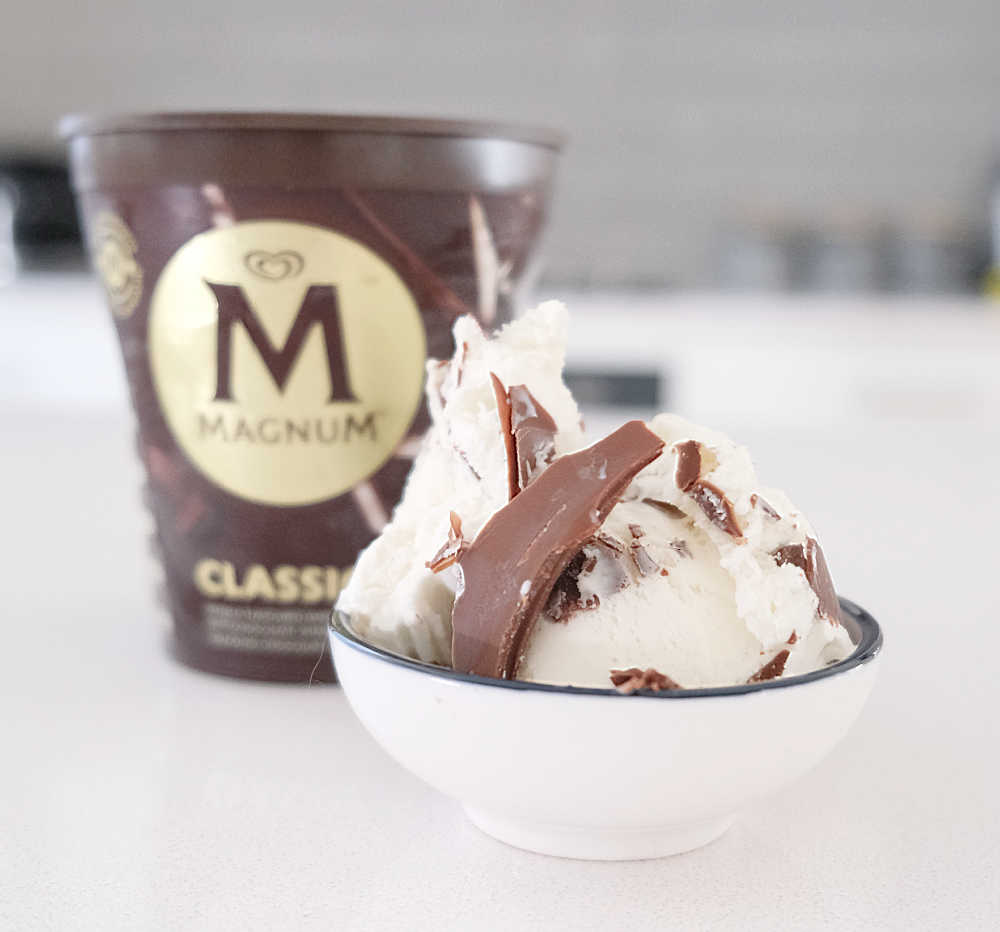 A bowl of Magnum Classic sitting on a bench top with the container in the background.