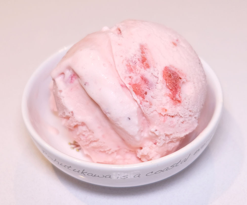 A white bowl containing Sara Lee Strawberry Ice Cream.