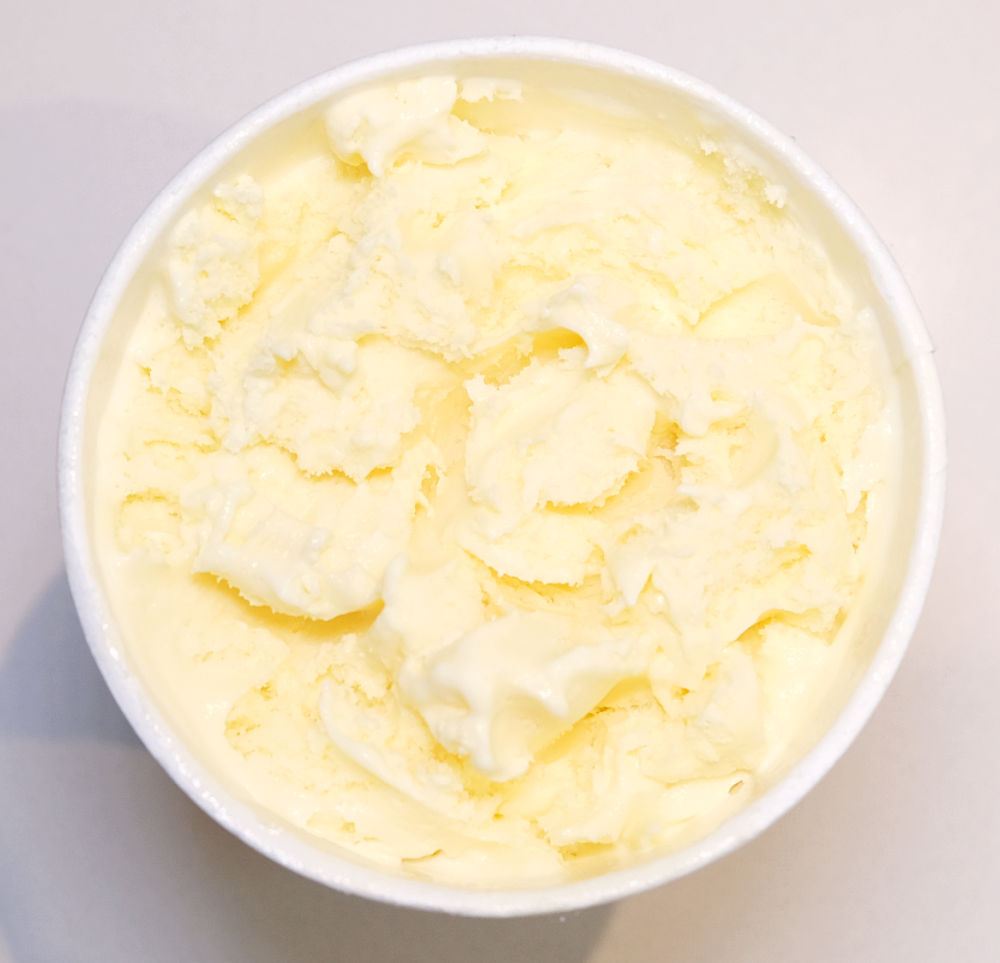 Top down photo showing a partly eaten container of Sara Lee Vanilla 1L.