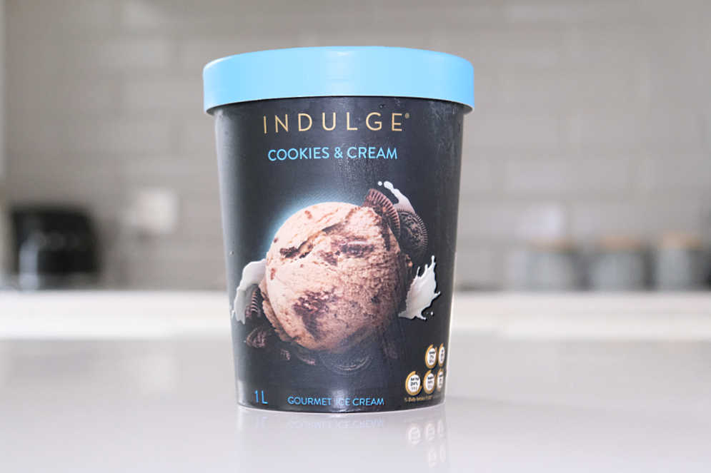 A pack of Indulge Cookies and Cream Ice Cream on a kitchen bench.