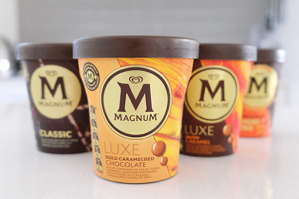 A line of Magnum ice cream tubs on the countertop.