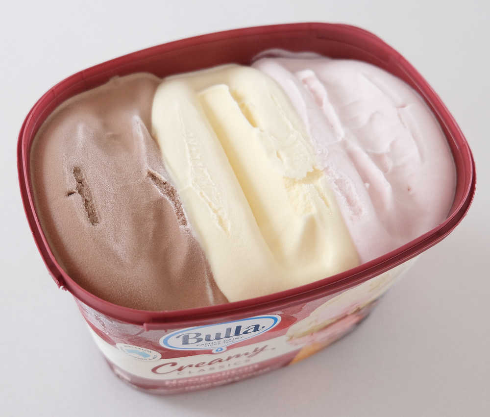 An unscooped pack of Creamy Classics Neapolitan 2L.