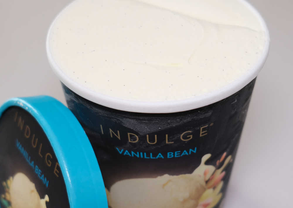 A pack of Vanilla Bean Ice Cream by Indulge with the lid removed.