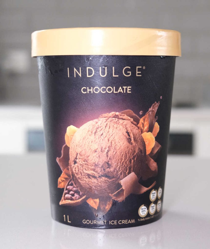 A vertical photo of the Indulge Chocolate Ice Cream packaging.