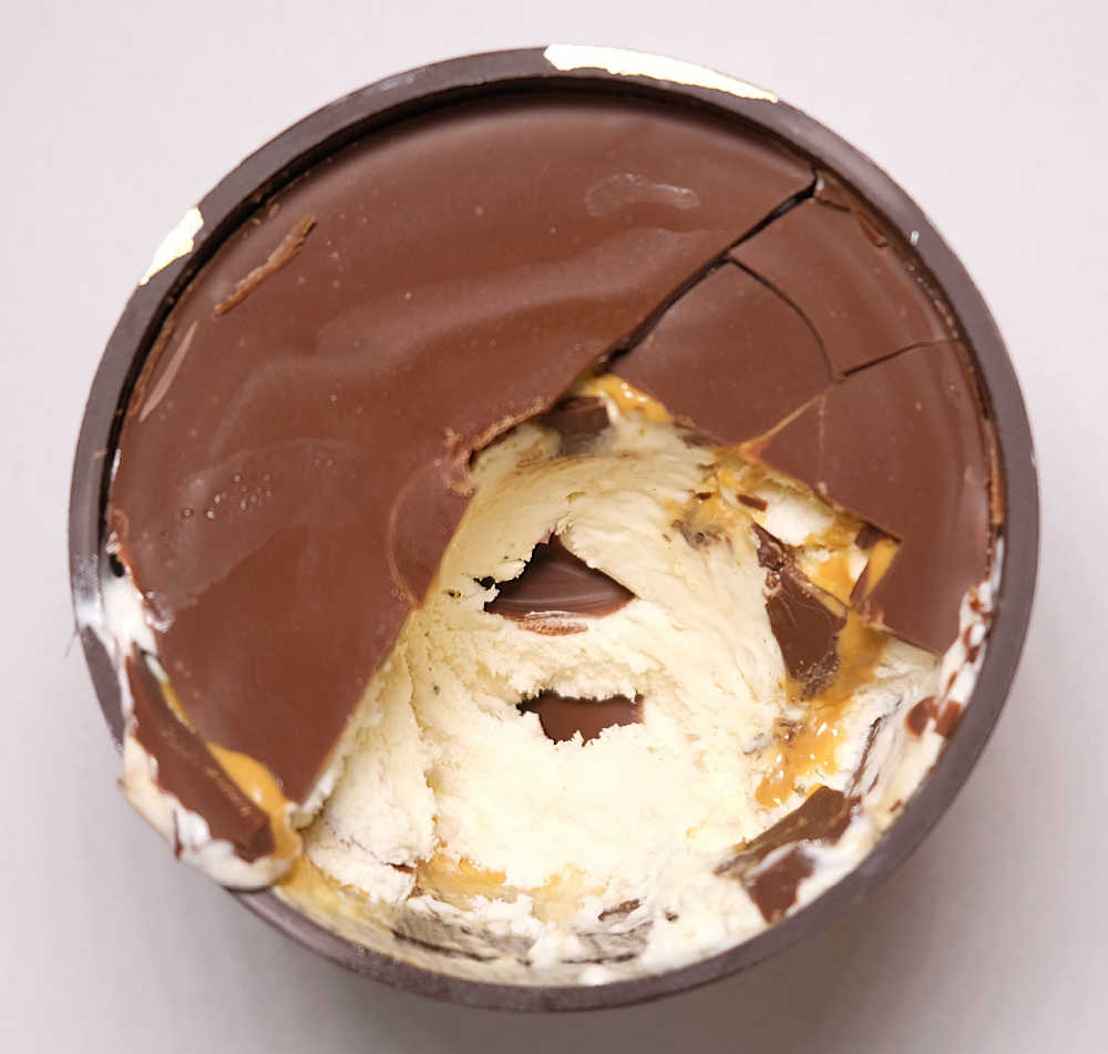 Bird's eye photo of the Luxe Salted Caramel 440ml tub with the choc shell cracked open.