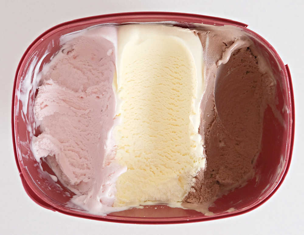 A bird's eye photo of a partly eated tub of Bulla Creamy Classics Neapolitan Ice Cream.