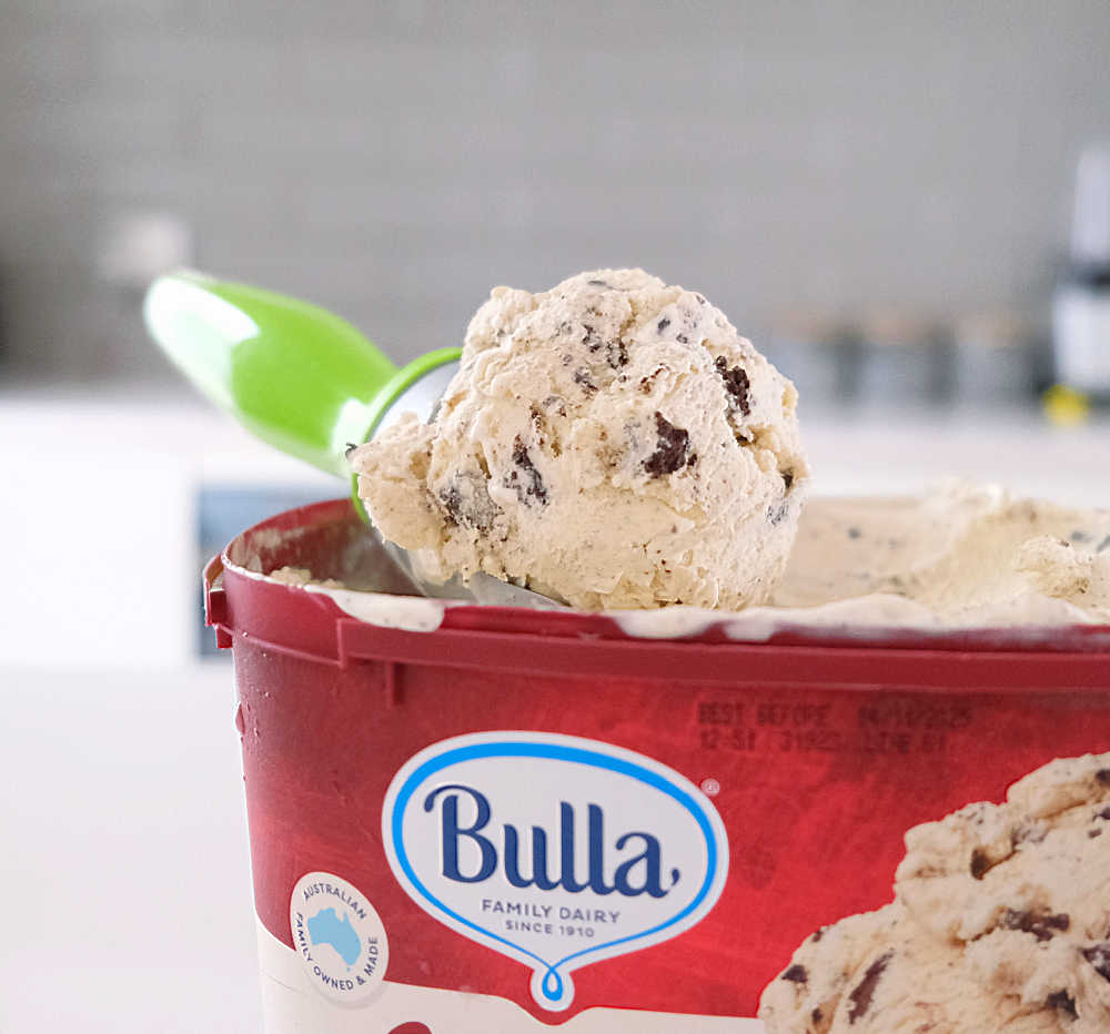 A scoop of Bulla Creamy Classics Cookies and Cream Ice Cream 2L.