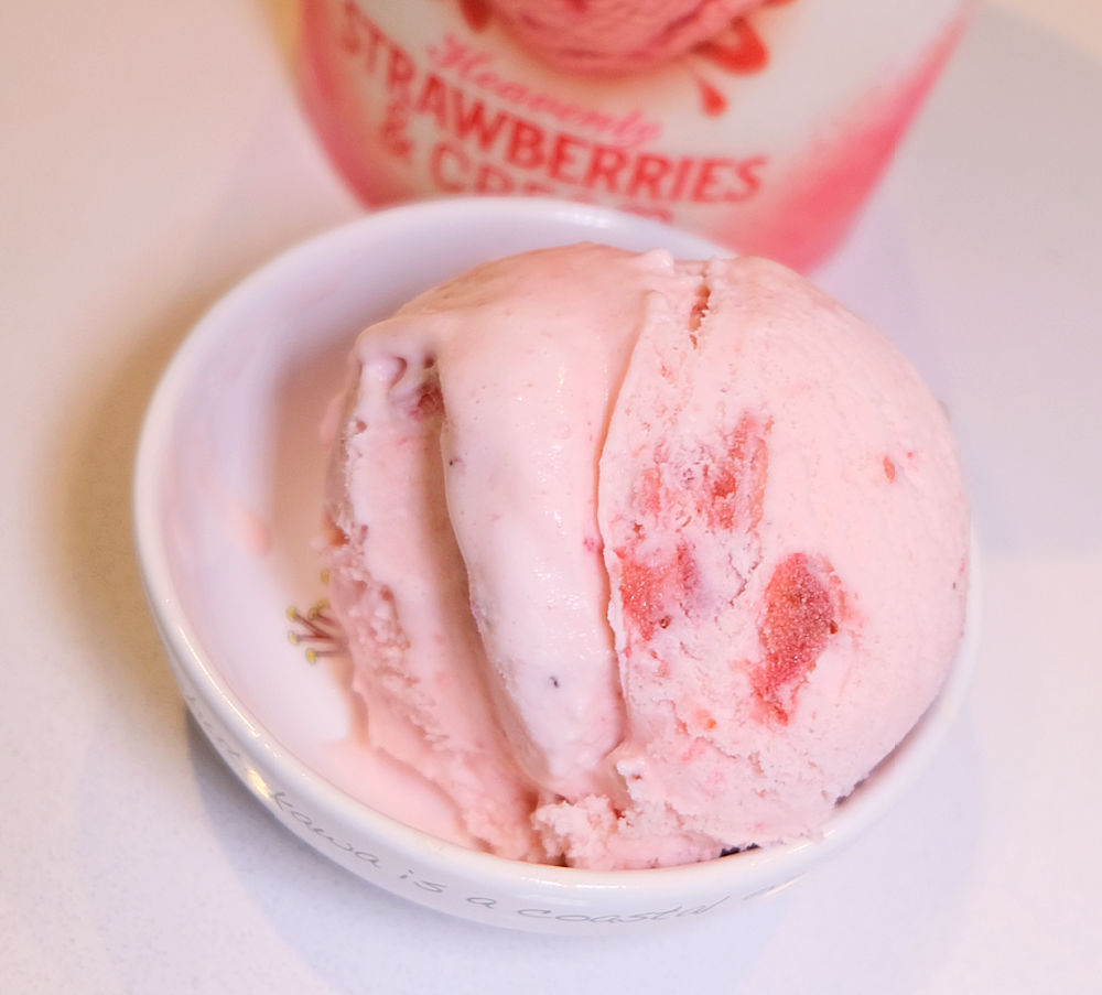 Bird's eye image of a bowl of strawberry ice cream.