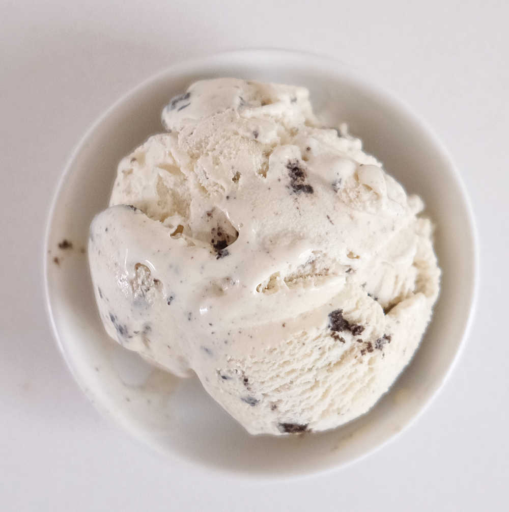 A bowl of Cookies & Cream Ice Cream isolated on a white background.