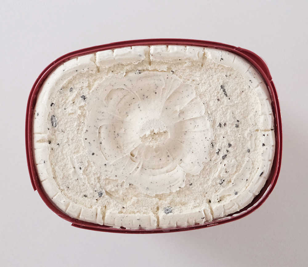 Top down image of unscooped tub of cookies and cream 2L.