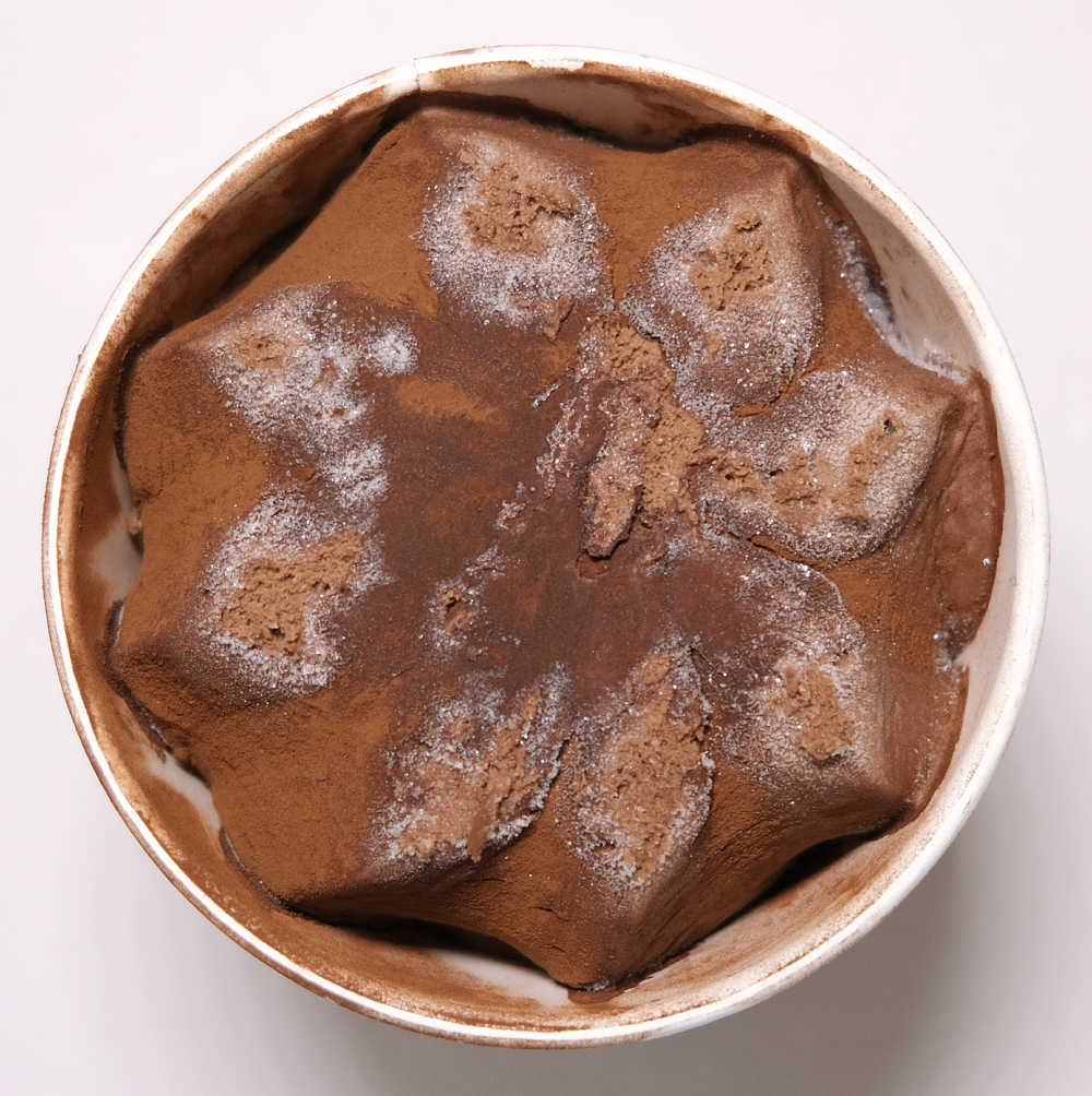 Bird's eye photo of freezer burn on the surface of a tub of Elato Dark Chocolate Truffle Gelato.
