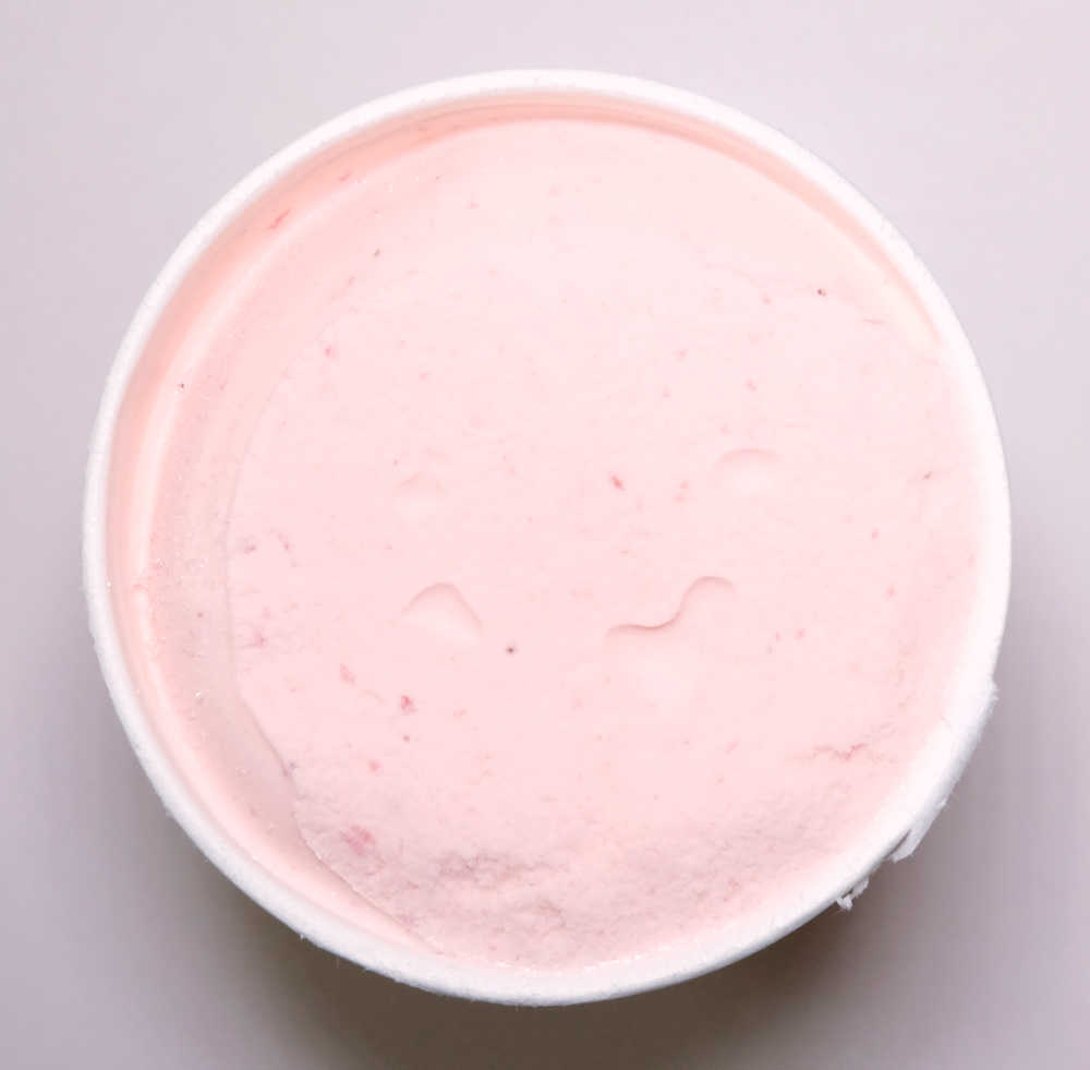 An unscooped container of Sara Lee Heavenly Strawberries and Cream Ice Cream 1L.