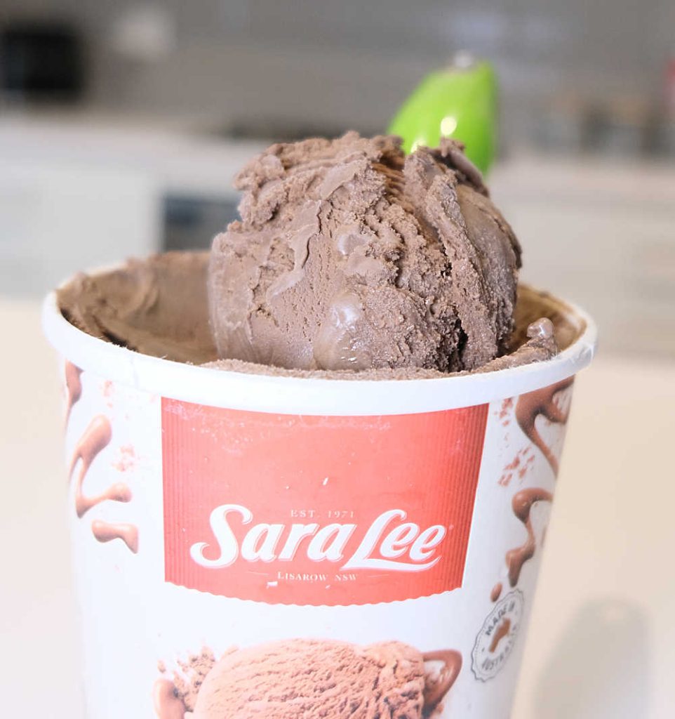 Closeup of a scoop of Sara Lee Chocolate resting on the container.