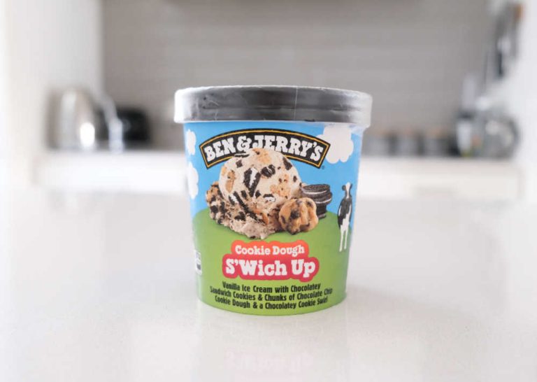 A pint of Ben & Jerry's Cookie Dough S'Wich Up Ice Cream sitting on a kitchen bench.