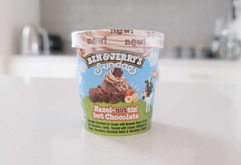 A pint of Ben & Jerry's Hazel-nuttin' but Chocolate Ice Cream on a kitchen bench.