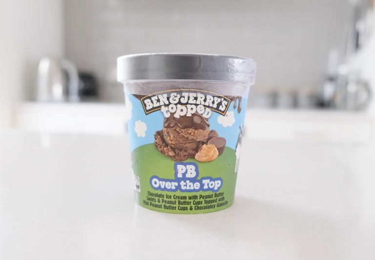 A pint of Ben & Jerry's Topped PB Over the Top Ice Cream sitting on a kitchen bench.