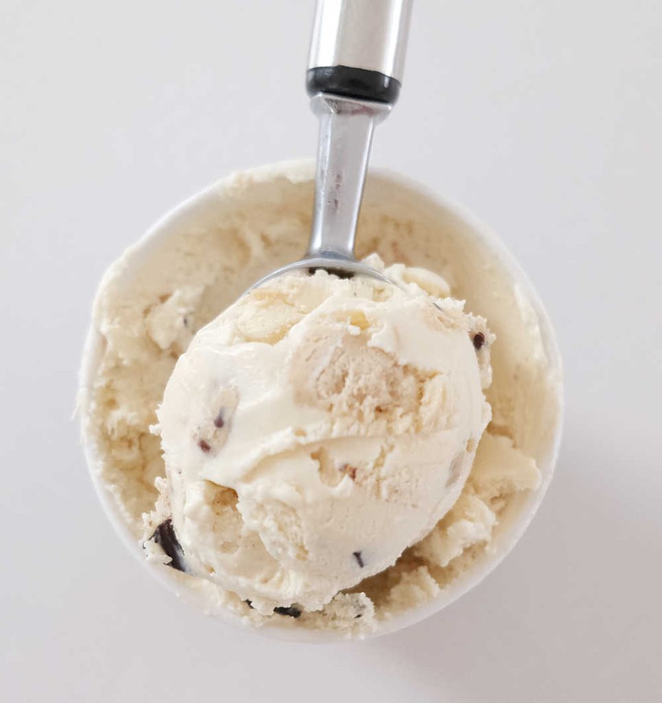 A top down photo of a scoop of Ben & Jerry's Chocolate Chip Cookie Dough Ice Cream resting on the top of the container.