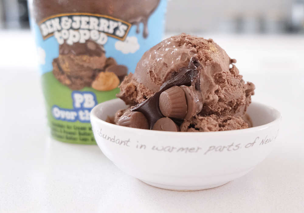 A bowl of B&J's PB Over the Top with the container in the background.