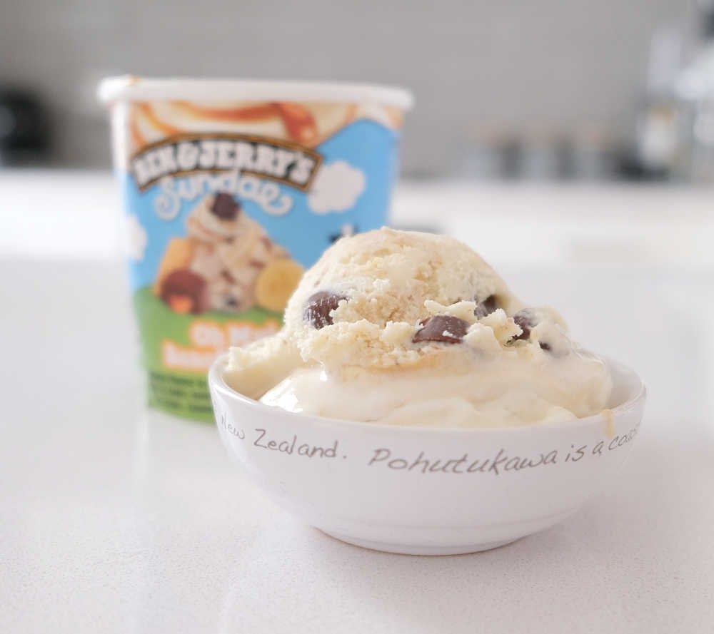A bowl of Ben & Jerry's Oh My Banoffee Pie 427ml with the container in the background.