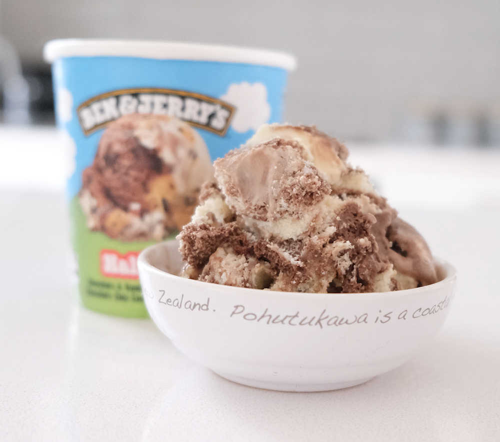 A bowl of Ben & Jerry's Half Baked Ice Cream with the packaging in the background.