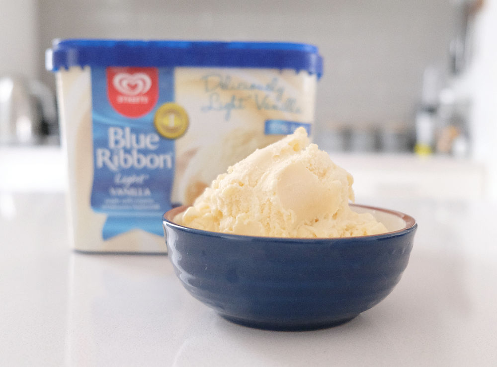 A bowl of Blue Ribbon Light Vanilla 2L with the container in the background.