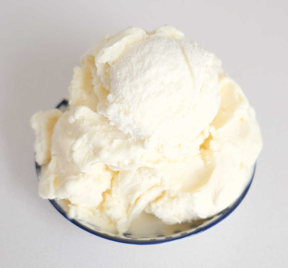 A bowl of Peters Light & Creamy Classic Vanilla on a white background.