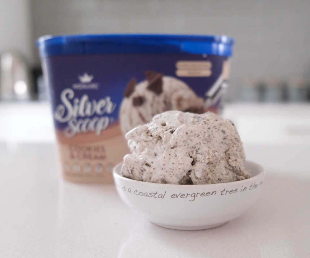 A bowl of Monarc Cookies & Cream with the packaging in the background.