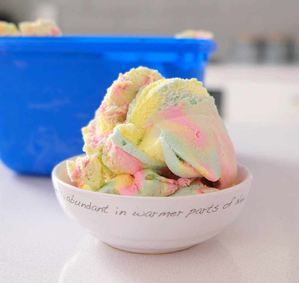 A bowl full of Peters Original Rainbow with the container in the background.