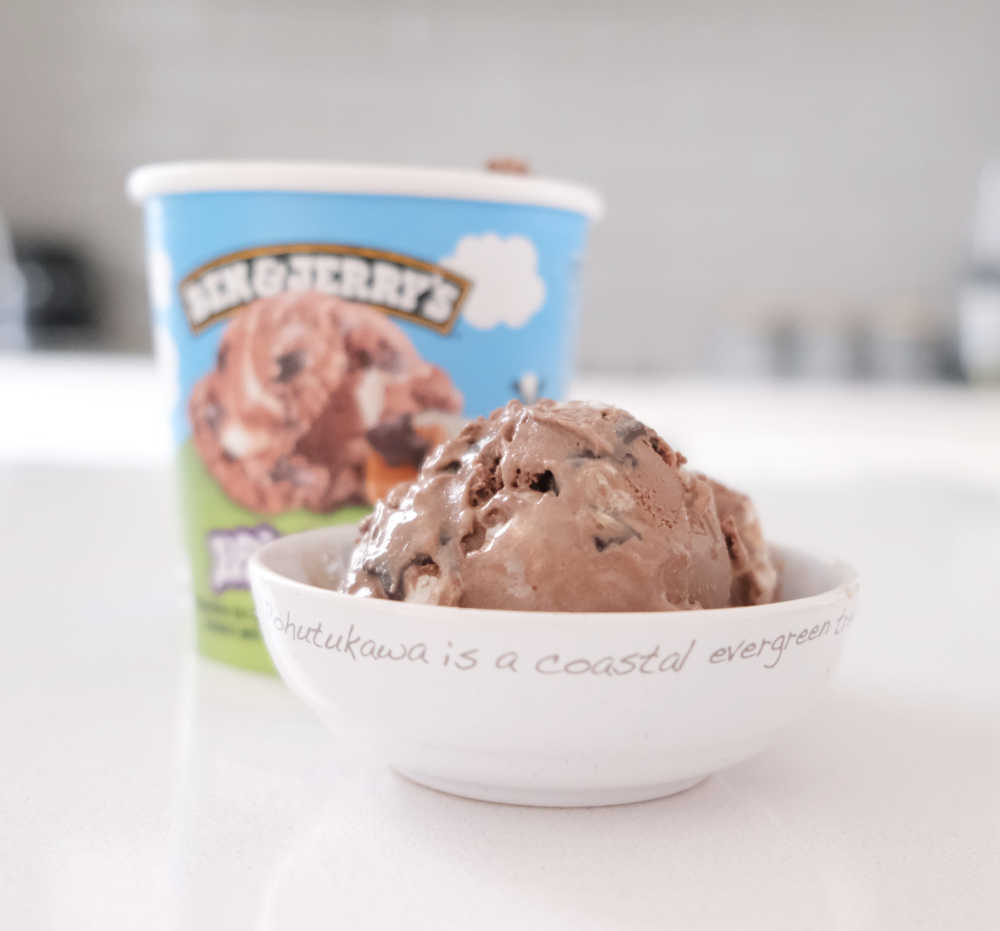 A bowl of Ben & Jerry's Phish Food Ice Cream with the pack in the background.