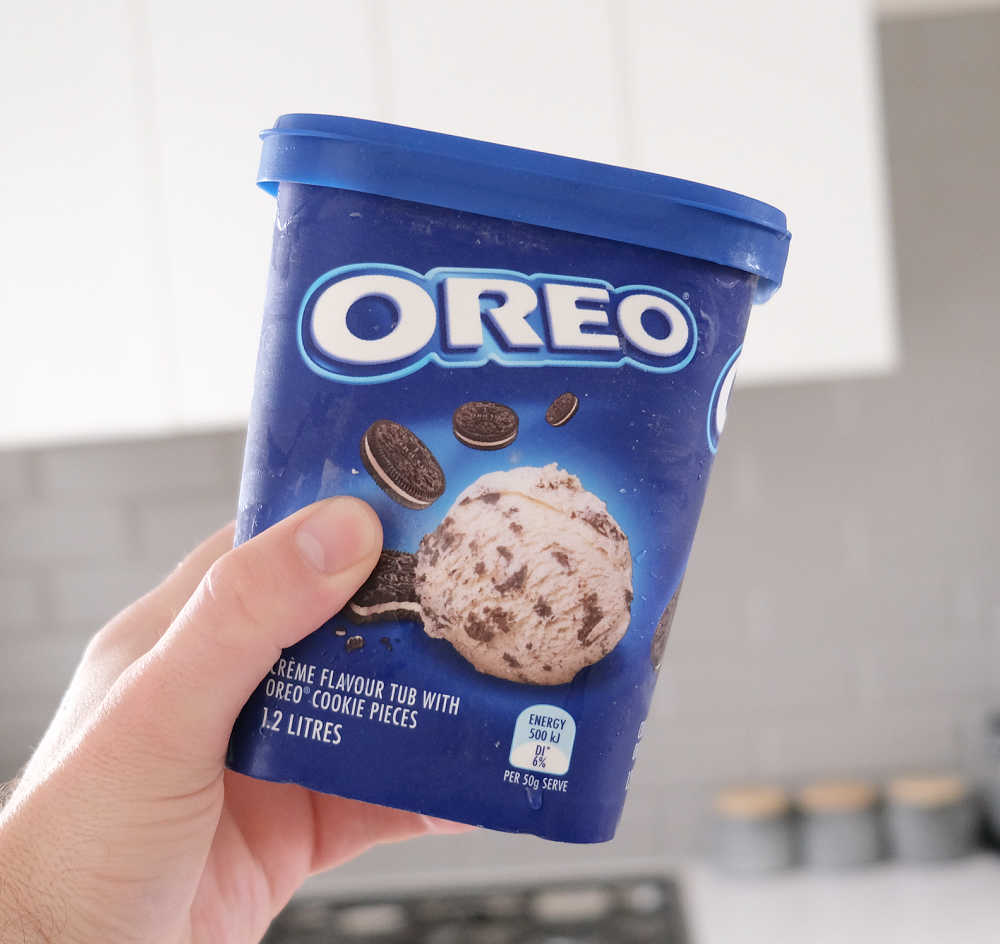 Holding a tub of Oreo 1.2L.