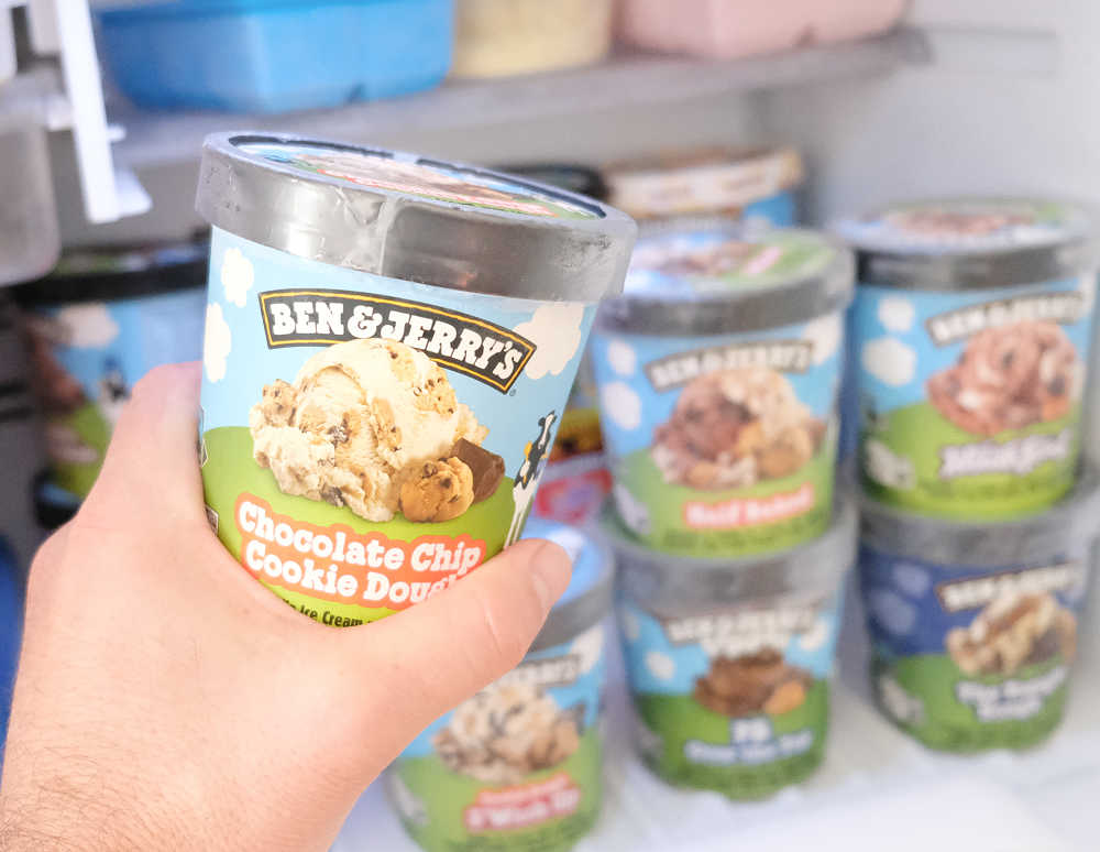 Holding a pack of Ben and Jerry's Choc Chip Cookie Dough Ice Cream 458ml.