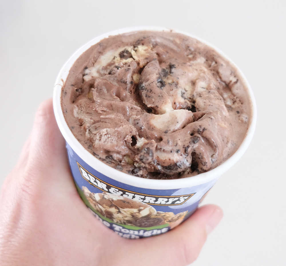 Holding a partly eaten pack of The Tonight Dough ice cream to show what's inside.