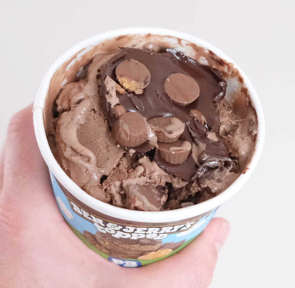 Holding an open pack of Ben & Jerry's Topped PB Over the Top.