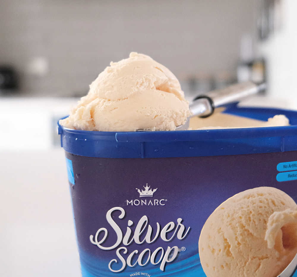 A tub of Monarc Silver Scoop Vanilla Ice Cream on a benchtop.