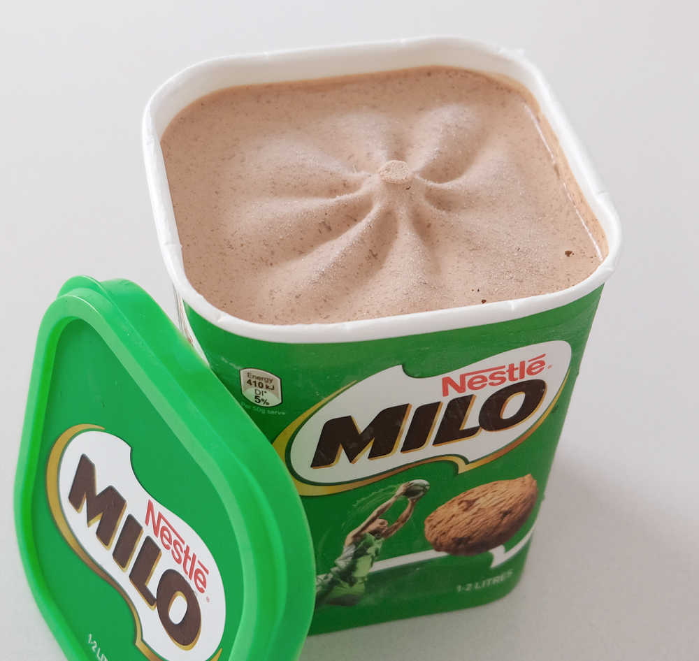 An opened conatiner of Nestle Milo frozen dessert.