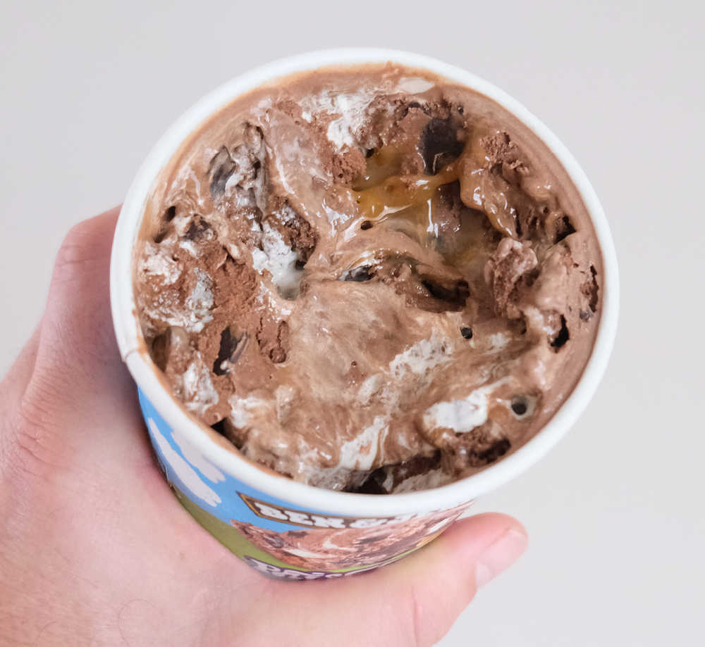 Holding a partly eaten container of Phish Food ice cream.