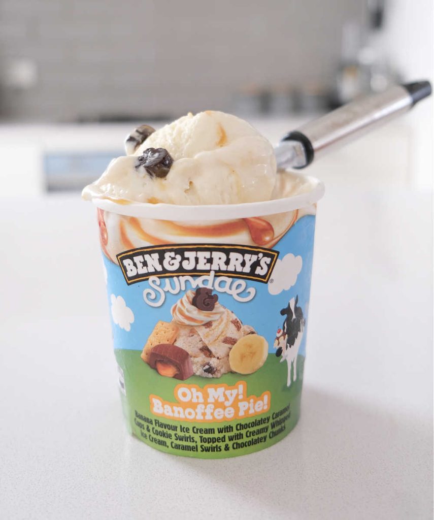 A scoop of Oh My Banoffee Pie Ice Cream resting on the top of the pack.