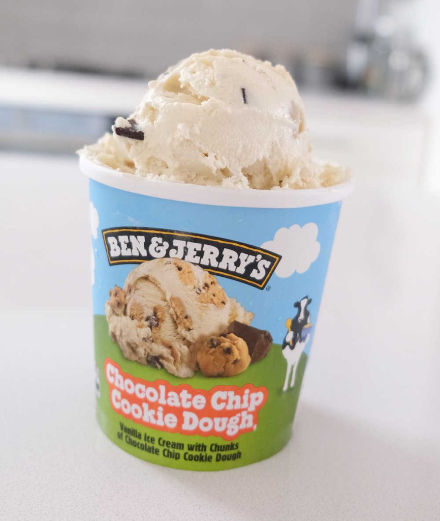 A vertical pack shot of an opened Ben & Jerry's Chocolate Chip Cookie Dough.