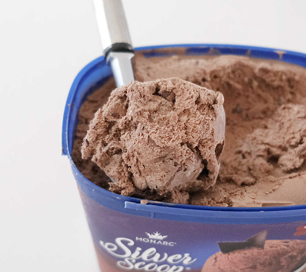 Closeup of a scoop of Monarc Silver Scoop Choc Chip Ice Cream sitting on the tub.