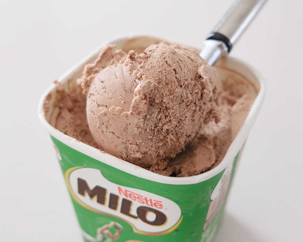 Closeup of a scoop of Milo ice cream resting on the tub.
