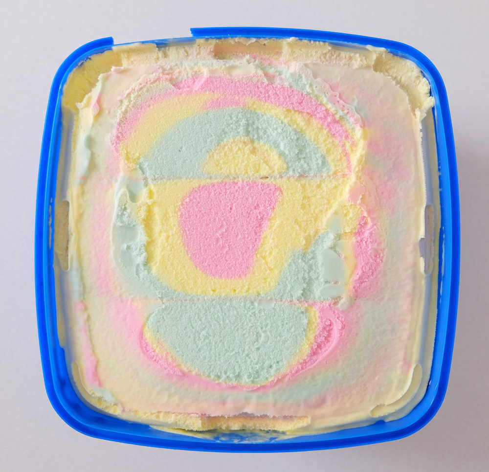 Top down image of an unscooped tub of Peters Original Rainbow.