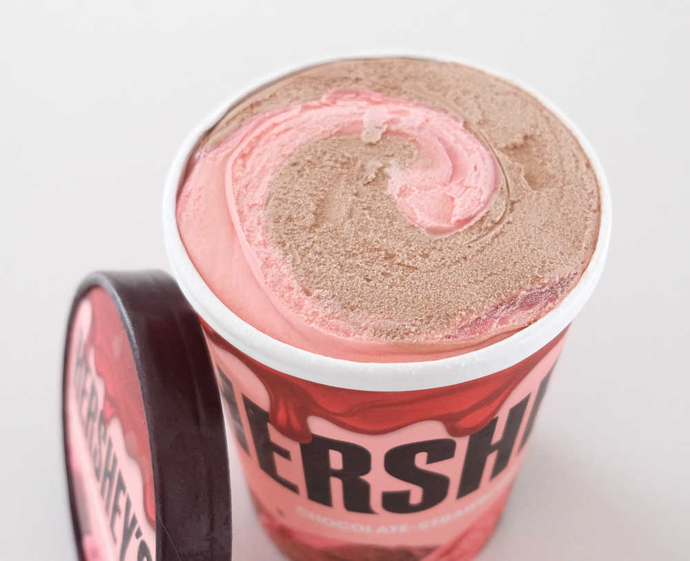 An unscooped pack of Hershey's Chocolate-Strawberry Ripple Ice Cream.
