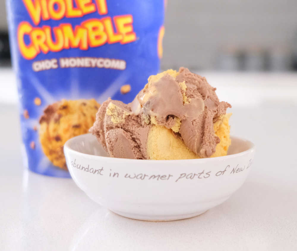 A bowl of Violet Crumble Ice Cream with the pack in the background.