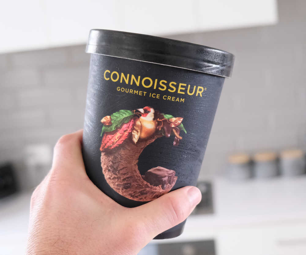 Holding a pack of Connoisseur Brownie Ice Cream.