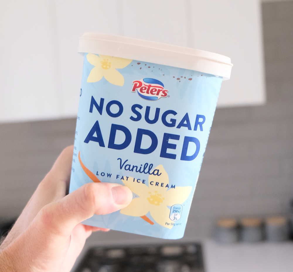 Holding a container of No Sugar Added Ice Cream by Peters.