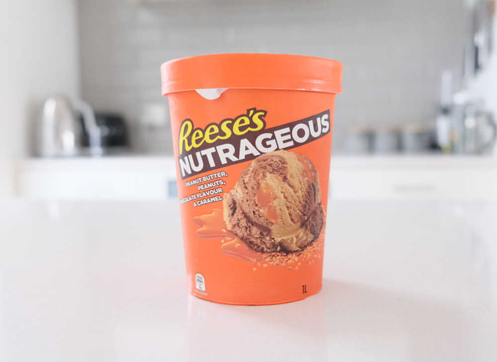 A tub of Reese's Nutrageous 1L on a kitchen bench.